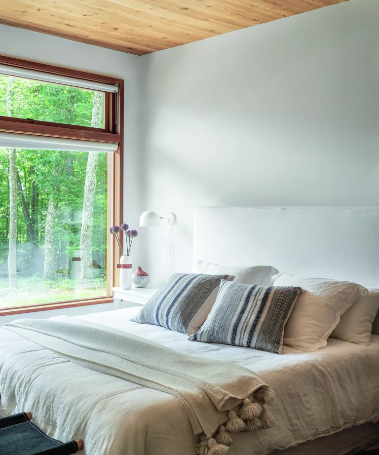 This sustainable woodland cabin has a calm and elegant modern country interior